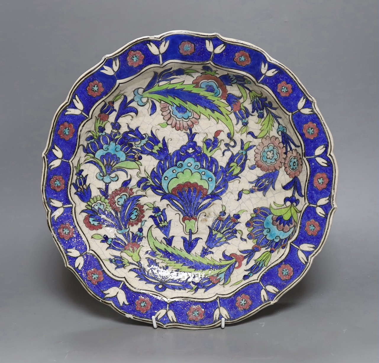 A large Persian fritware charger, in Iznik style, 36cm